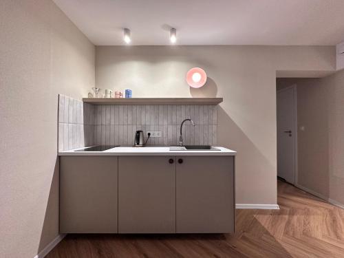 a kitchen with a sink and a counter at Piast in Karwia
