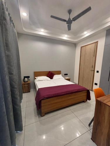 a bedroom with a bed and a ceiling fan at Hotel Venezia Grand in Gurgaon
