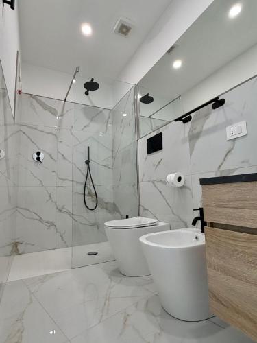 ein Badezimmer mit Dusche, Toilette und Waschbecken in der Unterkunft PoliHome in Monserrato