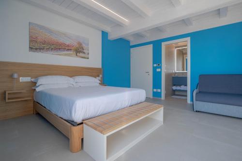 a bedroom with a bed and a blue wall at Villa Sarmassa in Narzole