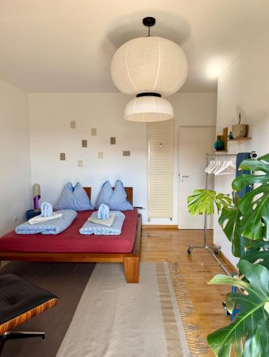 a room with a bed with blue pillows on it at Apartment Luk - Design trifft Zuhause in Furth im Wald