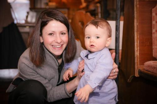 a woman holding a baby wearing a bow tie at Gasthof Post in Rennweg