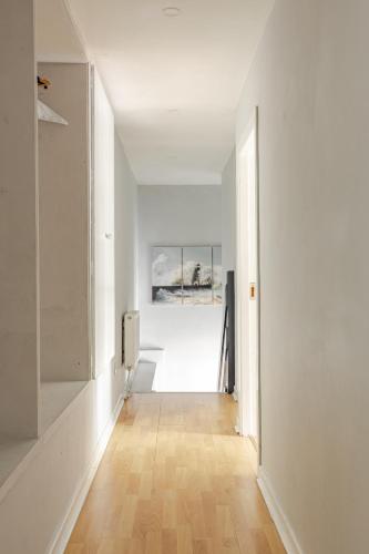 an empty hallway with white walls and a wooden floor at Explore the west in Loughrea