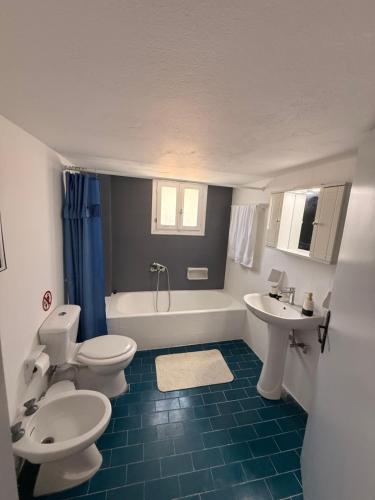 a bathroom with two toilets and a sink and a tub at Methoni Joanna House in Methoni