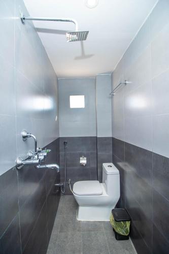 a bathroom with a toilet and a shower at Himalaya Forest Resort in Deorāli
