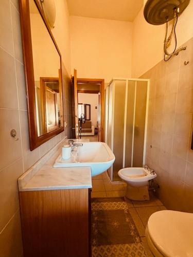 a bathroom with a sink and a toilet at Villetta Rose in Rena Majore