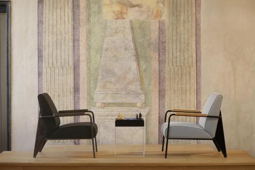 two chairs and a table in a room at Hotel Palazzo Grillo in Genova