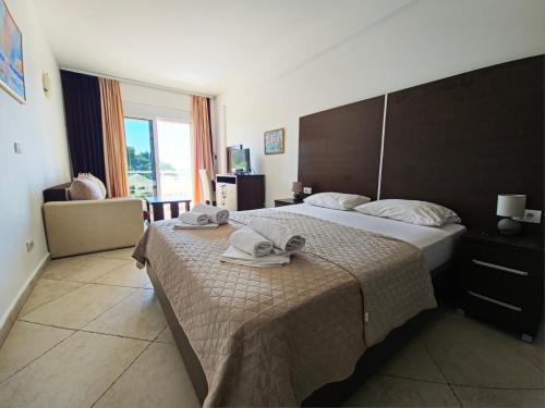 a hotel room with two beds with towels on the bed at Apartments Art in Ulcinj