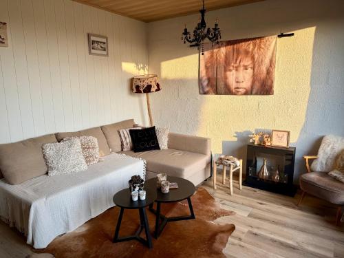 a living room with a couch and a table at Cabane La Folie Douce in Hotton