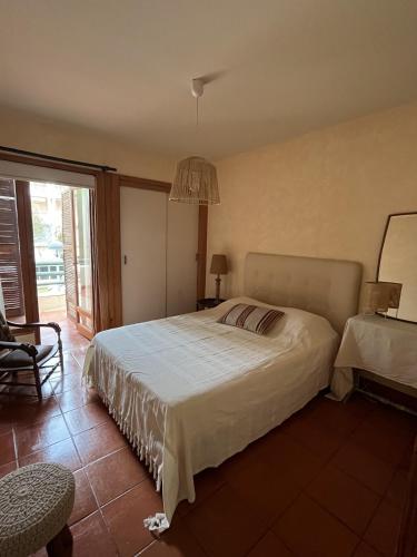 a bedroom with a large bed and a chandelier at Soltroia Beach House in Carvalhal