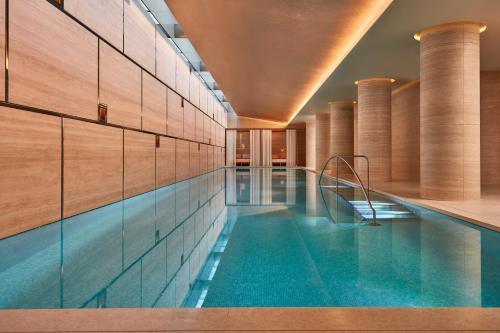 a swimming pool in a building with a swimming pool at The Emory, Maybourne in London