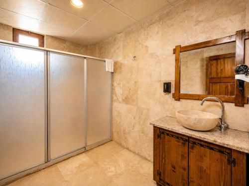 a bathroom with a sink and a shower at Cappadocia Elite Stone House in Göreme