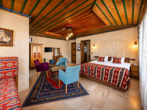 a bedroom with a bed and a table and chairs at Cappadocia Elite Stone House in Göreme