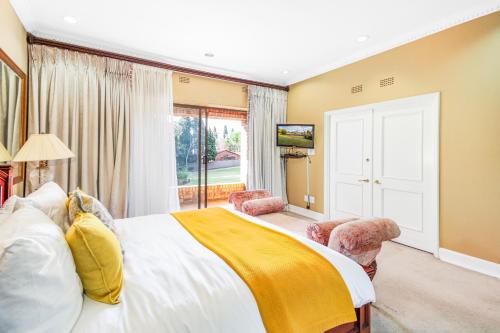 a bedroom with a large bed and a large window at Bryanston stays in Johannesburg