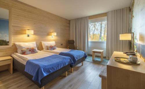 a hotel room with a bed and a desk at Hotel Ivalo in Ivalo