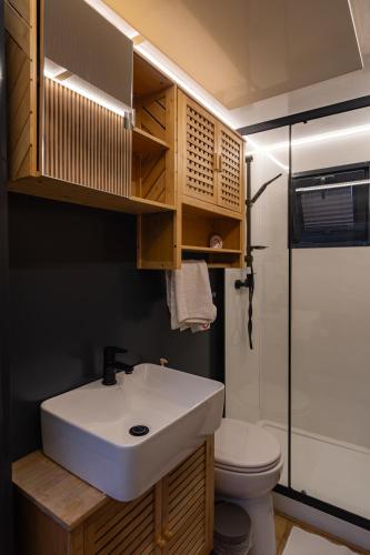 a bathroom with a white sink and a toilet at Prague River Houseboats - Private Bay in Prague
