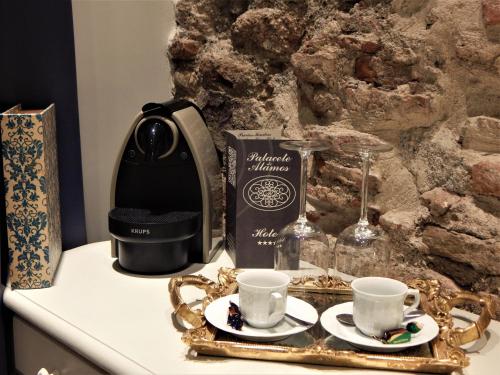 a coffee maker and two cups on a counter at Hotel Palacete de Alamos in Málaga