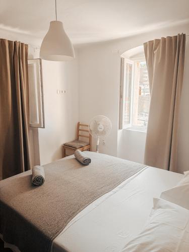 a bedroom with a large white bed with a window at Apartment Estera in Jelsa