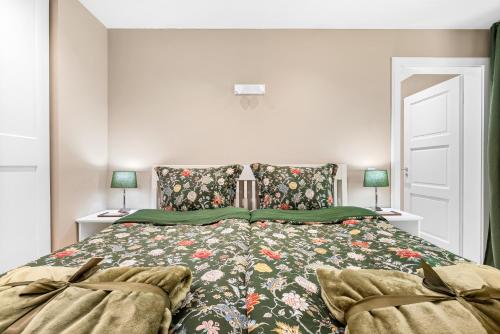 a bedroom with a bed with a floral bedspread at Wild Wilderness in Schaalby