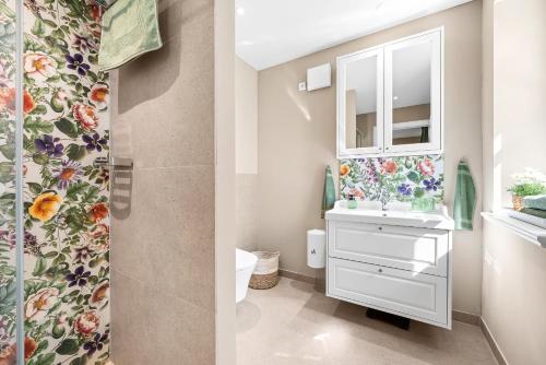 two pictures of a bathroom with a sink and a mirror at Wild Wilderness in Schaalby