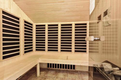 a sauna with wooden shutters and a bench at 8522-Grenaa-Nobilisvej-15 in Grenå