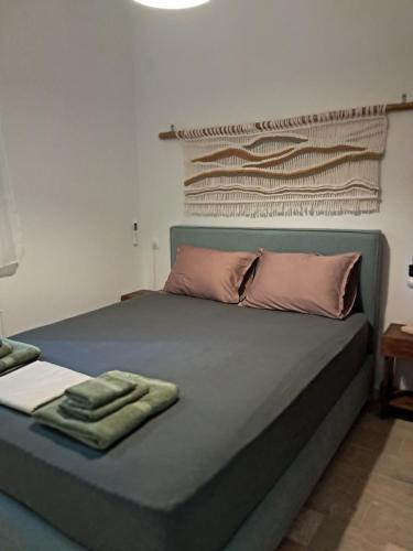 a bed with two towels on top of it at Asprocyclia House in Kalymnos