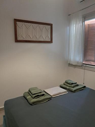 a table with two towels and a book on it at Asprocyclia House in Kalymnos