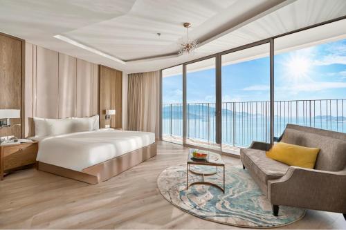 a hotel room with a bed and a couch at Nha Trang Oceanview Suites in Nha Trang