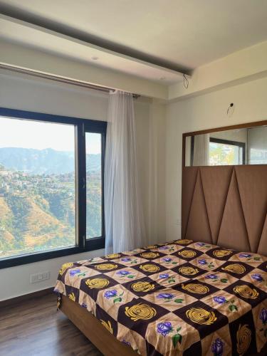 a bedroom with a bed and a large window at Potion's Villa - Shimla in Shimla