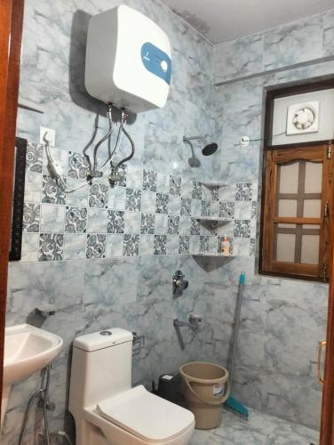 a bathroom with a toilet and a sink and a shower at Potion's Villa - Shimla in Shimla