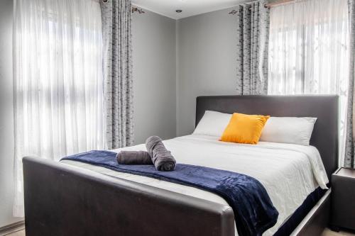 a bedroom with a bed with two pillows on it at Red Pillar in Maseru