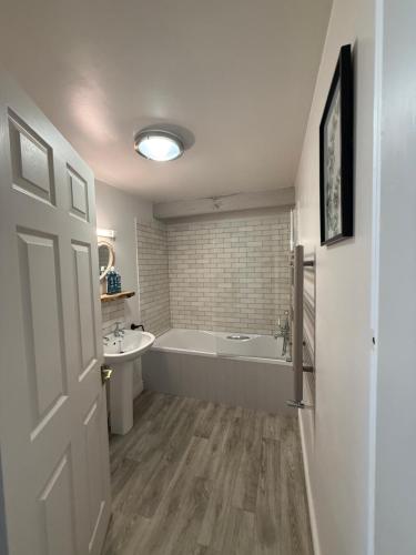 a bathroom with a tub and a sink at Bewerley Hall farm in Harrogate