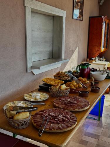 a table with many different types of food on it at Rural Resort Tron in Plužine