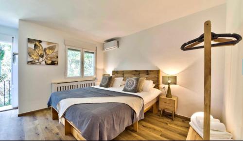 a bedroom with a large bed and a window at Villa Granadella in Jávea