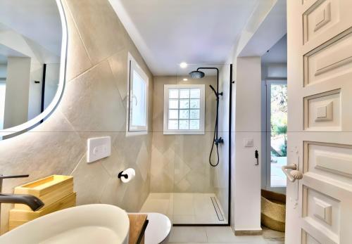 a bathroom with a shower and a sink at Villa Granadella in Jávea