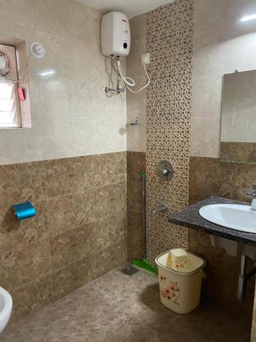 a bathroom with a sink and a toilet and a shower at Triyaah Pool View Studios Arpora, Goa in Arpora