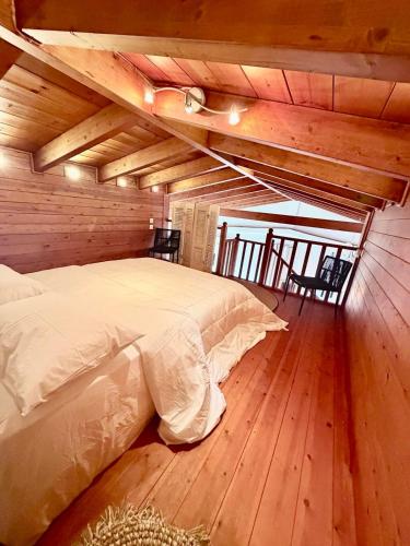 a bedroom with a bed in a wooden room at Casa Blue in Panayía Mesosporítissa