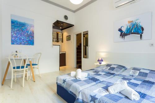 a bedroom with a blue and white bed and a kitchen at The heart of Dubrovnik in Dubrovnik