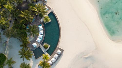 an aerial view of a beach with palm trees and boats at Constance Moofushi Maldives - All Inclusive in Himandhoo 