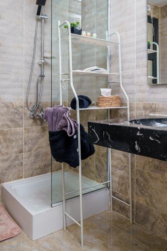a towel rack in a bathroom with a sink at Luxury Smart Home Entire Apartment with 2 Bedrooms in Madinaty in Madinaty