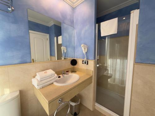 a bathroom with a sink and a mirror at Marina de Campios in Comillas