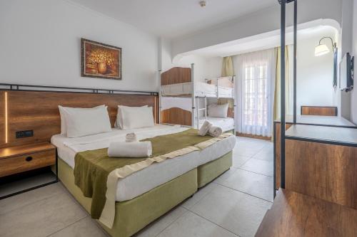a bedroom with a large bed with two pillows on it at Bitez Garden Life in Bitez