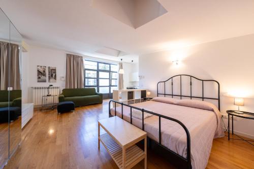 a bedroom with a bed and a living room at La Maison del Capestrano in Milan