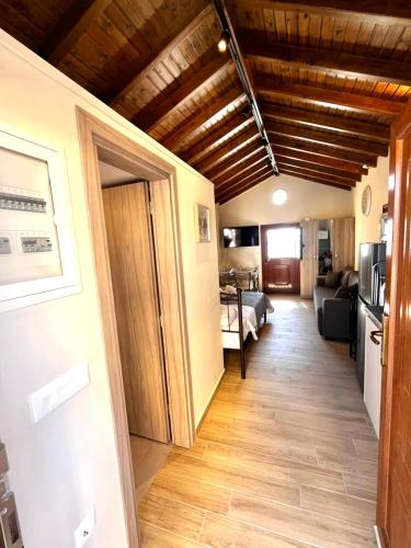 a hallway leading to a living room with wooden ceilings at Limanaki 1 in Chios