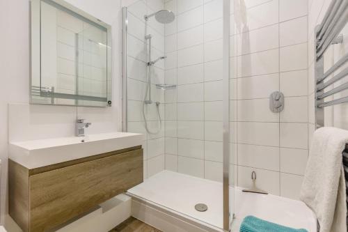 a white bathroom with a shower and a sink at 1 Bed in Cromer oc-1844 in Cromer