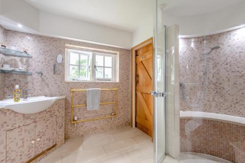 a bathroom with a sink and a shower at 5 Bed in Magham Down oc-sx942 in Hailsham
