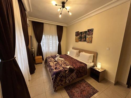 a hotel room with a bed and a window at ChallawaRiver Homes in Calabar