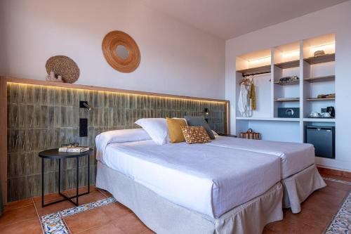 a bedroom with a large bed and a table at Estival Park Marena in La Pineda