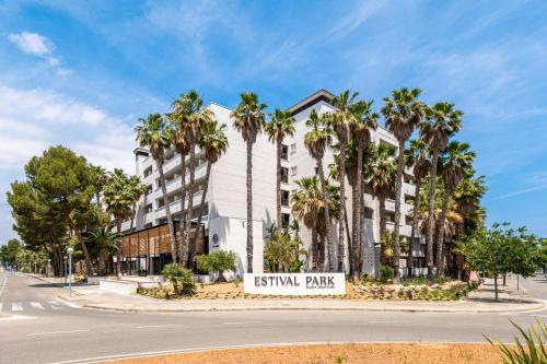 an exterior view of a hotel with palm trees at Estival Park Marena in La Pineda