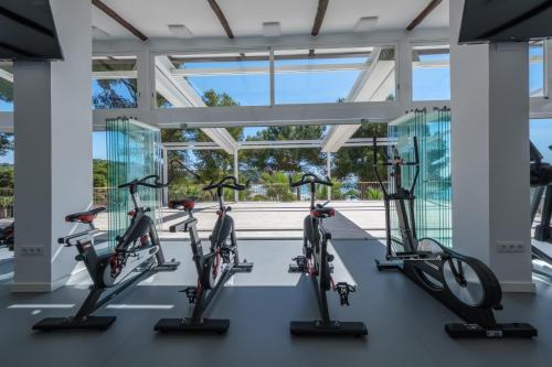 a group of bikes in a gym with windows at Camping Estival Torre de la Mora in Tamarit